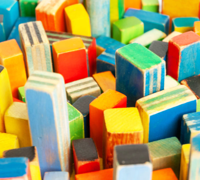 Wall sculpture, detail of painted forms standing in for a city block, J Schatz