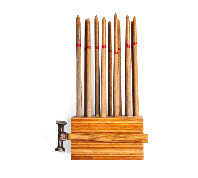 Wood and latex wall sculpture with a hammer mounted at center, J Schatz