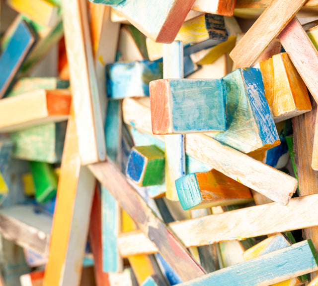 Detail of painted wood blocks and strips crossing in relief, J Schatz