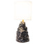 Amorphous table lamp 1, a broad craggy stoneware base in black metallic lava glaze under a fabric shade, by Jim Schatz, J Schatz