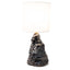 Amorphous table lamp 2, a tapering craggy stoneware base in black metallic lava glaze under a fabric shade, by Jim Schatz, J Schatz