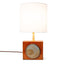 Geometria brick lamp 1, a blue-grey disc set into rust glazed stoneware, brass stem and fabric shade, by Jim Schatz, J Schatz