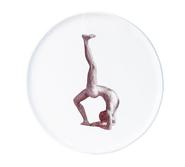 Brown oxide transfer of an inverted figure with one leg vertical on stoneware Gestures plate, J Schatz.
