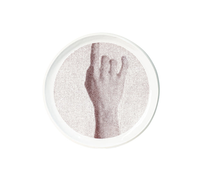 Brown oxide transfer of a raised forearm and open hand on stoneware Gestures plate, J Schatz.