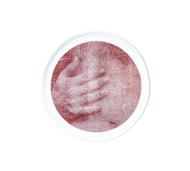 Brown oxide transfer of a hand gripping a shoulder on stoneware Gestures plate, J Schatz.