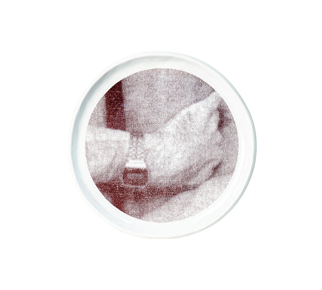 Brown oxide transfer of a hand resting at the waist on stoneware Gestures plate, J Schatz.