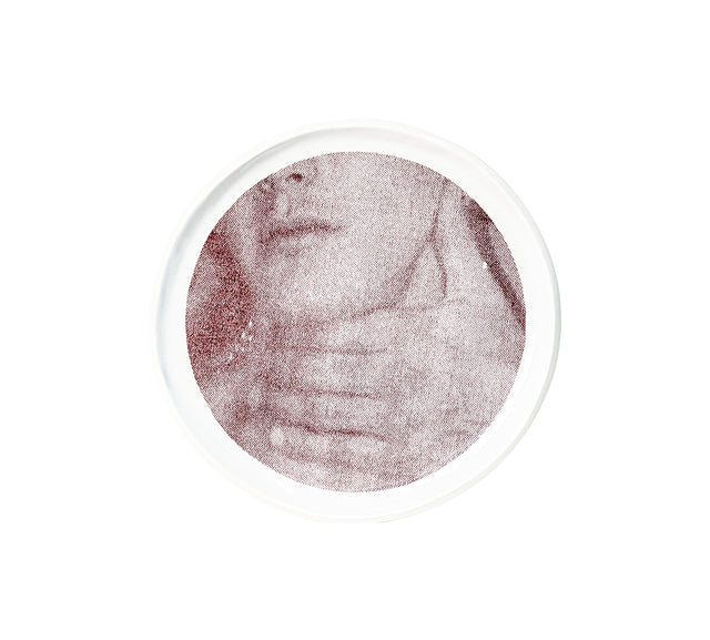 Brown oxide transfer of a torso and hand across the ribs on stoneware Gestures plate, J Schatz.