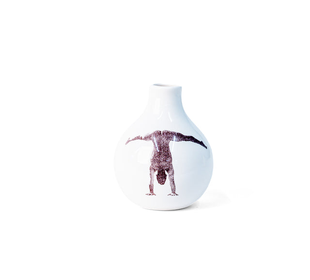 Brown oxide transfer of a handstand with legs split wide on porcelain Gestures bud vase, J Schatz.