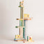 Small standing wood sculpture of figures gathered close, painted in soft washes, J Schatz