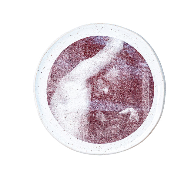 Brown oxide transfer of a figure with a raised arm on speckled stoneware plate, J Schatz and Peter Souza Jr.