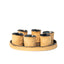 Round stoneware tray with six hand-built cups, raw speckled clay with blue-black glazed interiors, J Schatz